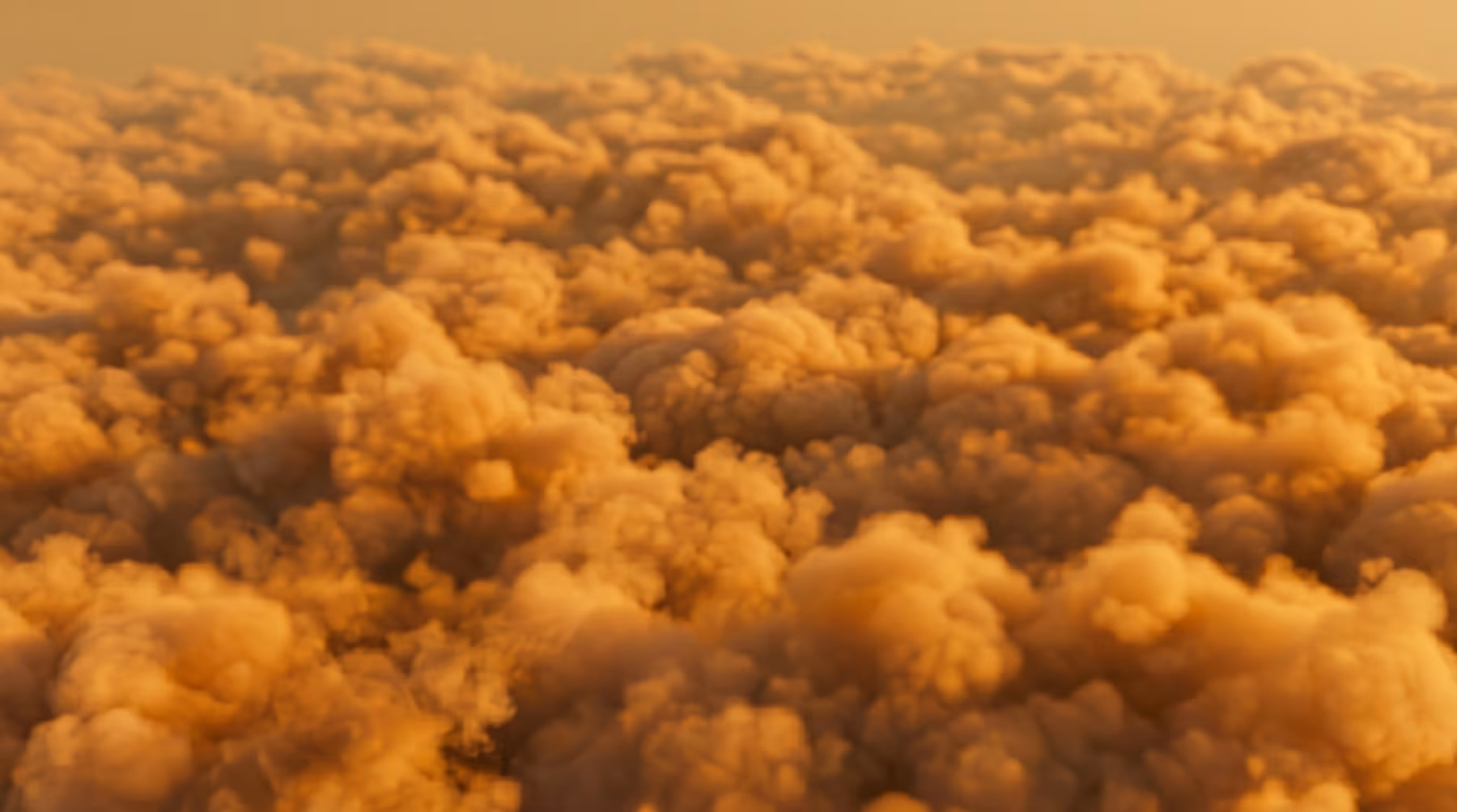 Golden clouds fill the sky, offering a serene aerial view for your next luxury travel planning session.